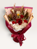 Autumn Embrace bouquet with red and brown preserved roses, ivory hydrangea and burgundy wrapping