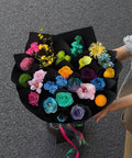 Colorful preserved bouquet in black wrapping