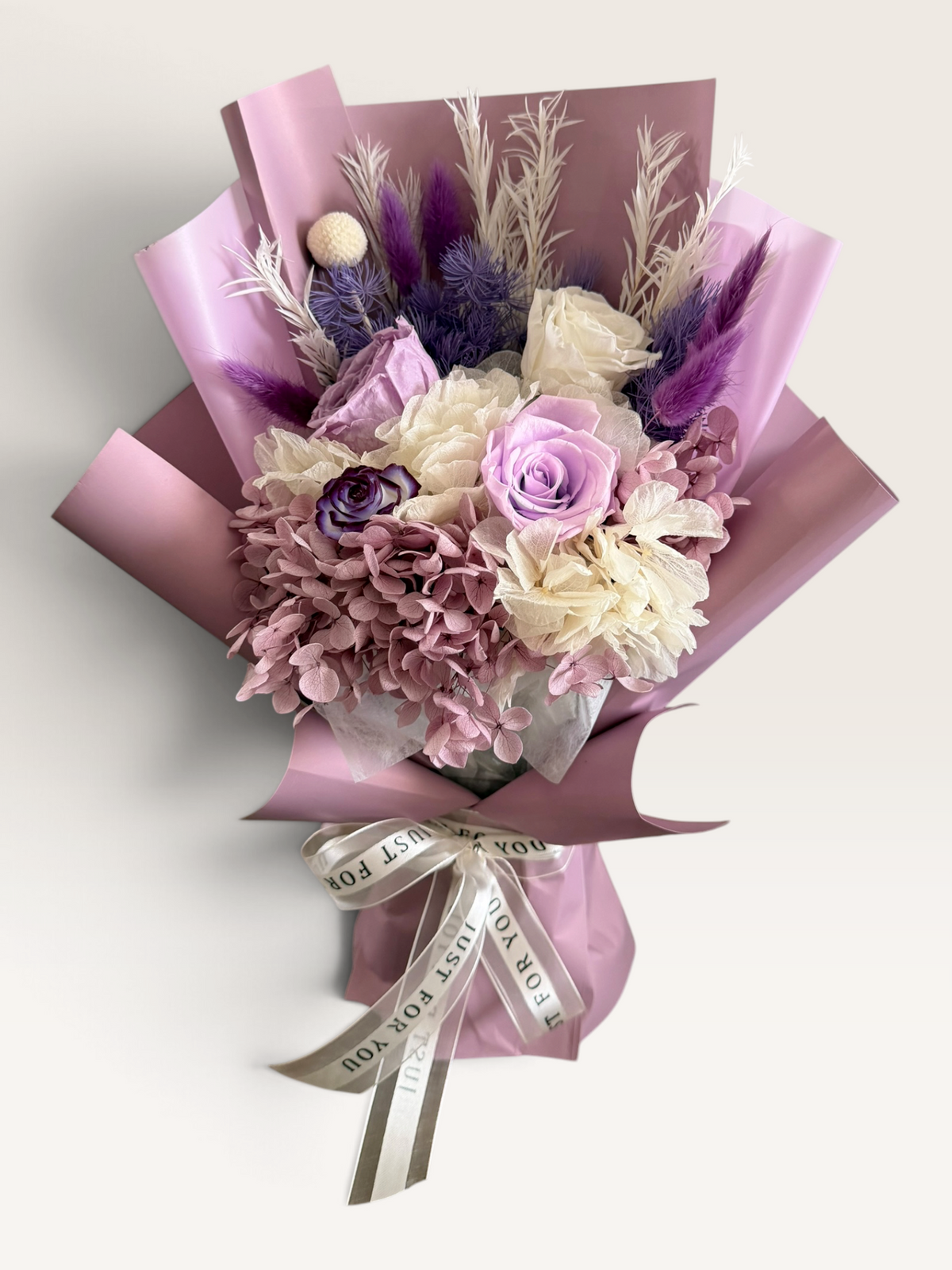 Lavender Poetry preserved bouquet with lavender roses, dusty pink and ivory hydrangeas and purple accents